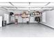 A spacious two-car garage featuring epoxy flooring and overhead storage racks at 5129 Devonshire Rd, Denver, NC 28037
