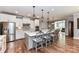 Bright and spacious kitchen features white cabinets, a large island with seating, and stainless steel appliances at 5129 Devonshire Rd, Denver, NC 28037
