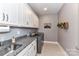 A laundry room featuring a sink, gray cabinets, granite countertops, washer, and dryer at 5129 Devonshire Rd, Denver, NC 28037
