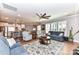 Open-concept living area with hardwood floors, a large fan, and seamless flow into the kitchen at 5129 Devonshire Rd, Denver, NC 28037