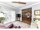 Cozy living room featuring light gray walls, a decorative ceiling fan and an opening to the kitchen and dining area at 5129 Devonshire Rd, Denver, NC 28037