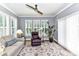 Cozy living room with a ceiling fan, large windows, and comfortable seating at 5129 Devonshire Rd, Denver, NC 28037