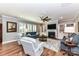 Cozy living room with fireplace, built-in shelving, hardwood floors, and comfortable seating arrangement at 5129 Devonshire Rd, Denver, NC 28037