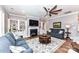 Inviting living room featuring a fireplace, built-in cabinets, hardwood floors, and comfortable sofas at 5129 Devonshire Rd, Denver, NC 28037