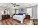 A spacious main bedroom features a tray ceiling, hardwood floors and windows with plantation shutters at 5129 Devonshire Rd, Denver, NC 28037