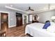 View of the main bedroom with a tray ceiling, hardwood floors and ensuite bathroom at 5129 Devonshire Rd, Denver, NC 28037