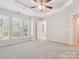 Spacious bedroom featuring tray ceiling, plush carpet, and abundant natural light at 570 Sixth Baxter Xing # 16, Fort Mill, SC 29708