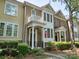 Brick townhouse with a charming balcony, covered porch, manicured landscaping, and American flag at 570 Sixth Baxter Xing # 16, Fort Mill, SC 29708