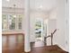 Inviting foyer with hardwood floors, stairs, and an arched window above the front door at 570 Sixth Baxter Xing # 16, Fort Mill, SC 29708