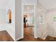 Hallway with hardwood floors leading to the kitchen featuring a pantry and stainless steel appliances at 570 Sixth Baxter Xing # 16, Fort Mill, SC 29708