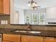 Eat-in kitchen with dark countertops, a stainless steel sink and view into the living room at 570 Sixth Baxter Xing # 16, Fort Mill, SC 29708