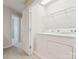 Bright laundry room with white washer, dryer, and shelving for storage at 570 Sixth Baxter Xing # 16, Fort Mill, SC 29708