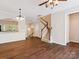 Spacious living room featuring hardwood floors, a staircase, and elegant lighting fixtures at 570 Sixth Baxter Xing # 16, Fort Mill, SC 29708