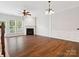 Bright living room showcasing a fireplace, hardwood floors, and natural light from large windows at 570 Sixth Baxter Xing # 16, Fort Mill, SC 29708