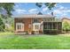 The backyard features a screened porch and patio area, with a well-manicured lawn at 6612 Saunton Ct, Charlotte, NC 28277