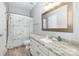 Bathroom featuring a single sink vanity with a gray marble countertop and a patterned shower curtain over the tub at 6612 Saunton Ct, Charlotte, NC 28277