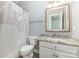 Bathroom featuring a single sink vanity with a granite countertop and a patterned shower curtain over the tub at 6612 Saunton Ct, Charlotte, NC 28277