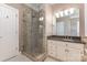 This primary bathroom features a glass enclosed shower, tiled floor and granite countertop vanity at 6612 Saunton Ct, Charlotte, NC 28277