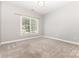 Bedroom featuring neutral walls and carpet, a window with blinds, and ample natural light, creating a simple atmosphere at 6612 Saunton Ct, Charlotte, NC 28277