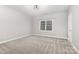 Bedroom featuring neutral walls and carpet, a window with blinds, and ample natural light, creating a serene atmosphere at 6612 Saunton Ct, Charlotte, NC 28277