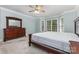 Bedroom with soft carpet and light blue walls, complete with large windows and decorative trim at 6612 Saunton Ct, Charlotte, NC 28277