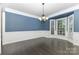 Dining room features wood floors, bay windows, white wainscoting, and a chandelier at 6612 Saunton Ct, Charlotte, NC 28277