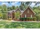 Charming brick home featuring manicured landscaping, a walkway and a two-story entryway at 6612 Saunton Ct, Charlotte, NC 28277