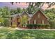 Charming brick home featuring manicured landscaping, a walkway and a two-story entryway at 6612 Saunton Ct, Charlotte, NC 28277