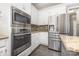This kitchen features stainless steel appliances, granite counters, and white cabinets for a modern feel at 6612 Saunton Ct, Charlotte, NC 28277