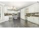 Bright kitchen with white cabinets, stainless steel appliances, and an island at 6612 Saunton Ct, Charlotte, NC 28277