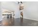 Open-concept living space with hardwood floors and staircase leading to the second floor at 6612 Saunton Ct, Charlotte, NC 28277