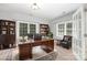 Home office with hardwood floors, bright windows, built-in shelving, and French doors is perfect for work at 6612 Saunton Ct, Charlotte, NC 28277