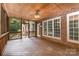 Relax on this screened in porch with brick accent walls, a wood ceiling, and views of the outdoors at 6612 Saunton Ct, Charlotte, NC 28277