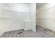 Spacious walk-in closet with carpet flooring and built-in shelving, offering ample storage space at 6612 Saunton Ct, Charlotte, NC 28277