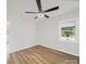 Bright bedroom features a ceiling fan, wood-look flooring and a window overlooking greenery at 821 1St St, Kings Mountain, NC 28086