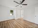 Bright bedroom featuring new vinyl floors, a ceiling fan, two windows and an en suite bathroom, designed for comfort and privacy at 821 1St St, Kings Mountain, NC 28086