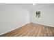 A bright bedroom with wood-look floors, a window, and neutral paint at 821 1St St, Kings Mountain, NC 28086