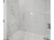 Updated shower featuring white marble-look tile and sleek, silver fixtures at 821 1St St, Kings Mountain, NC 28086