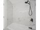 Modern shower featuring elegant marble-look tile and sleek, matte black fixtures at 821 1St St, Kings Mountain, NC 28086
