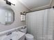 Cozy bathroom features a modern vanity, shower curtain and modern lighting at 101 Treeline Dr, Belmont, NC 28012