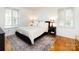 Stylish bedroom with a patterned rug, hardwood floors, and windows with shutters at 101 Treeline Dr, Belmont, NC 28012