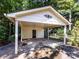 Spacious carport with white painted supports and a storage shed in the back at 101 Treeline Dr, Belmont, NC 28012