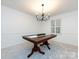 Traditional dining room features a wood table, neutral walls, and modern chandelier for elegant dining at 101 Treeline Dr, Belmont, NC 28012