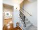 Hallway with hardwood floors leading to a kitchen with white cabinets at 101 Treeline Dr, Belmont, NC 28012