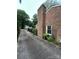 Brick home with tall chimney, mature trees, and view of the long driveway at 101 Treeline Dr, Belmont, NC 28012