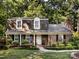 Charming brick home featuring dormer windows and well-manicured landscaping at 101 Treeline Dr, Belmont, NC 28012