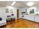 Bright kitchen with hardwood floors, white cabinets, granite countertops, and a cozy breakfast nook at 101 Treeline Dr, Belmont, NC 28012