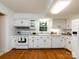 Bright kitchen features white cabinets, granite countertops, hardwood floors, and modern appliances at 101 Treeline Dr, Belmont, NC 28012