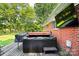 Relaxing back deck featuring a hot tub, grill, and an outdoor mounted TV for ultimate enjoyment at 1104 Pump Station Rd, Kannapolis, NC 28081