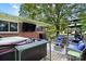 Outdoor living on this back deck has seating, a hot tub, and a mounted TV for relaxation and entertainment at 1104 Pump Station Rd, Kannapolis, NC 28081
